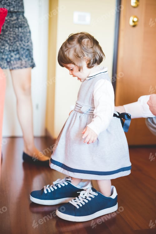 Preview: Female toddler wearing large trainer shoes