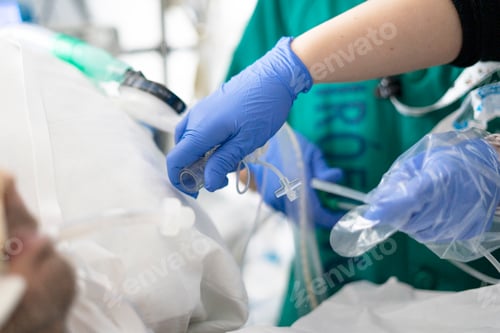 Preview: Doctor holding endotracheal tube preparing intubation procedure in hospital