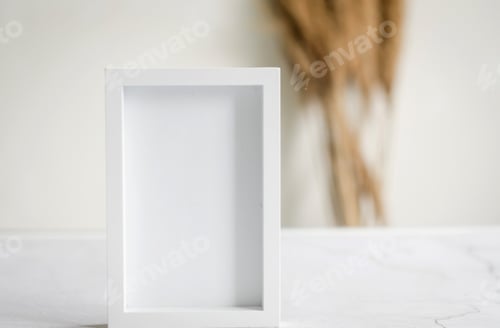 Preview: Empty frame and bouquet of wheat spikelets in a bottle on grey background