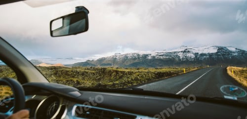 Preview: Scene of adventure travel in the mountains driving a car on the road with clouds and snow.