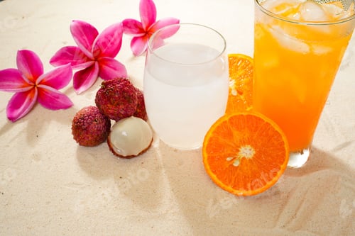 Preview: Beautiful shot of litchi and orange juices on a table