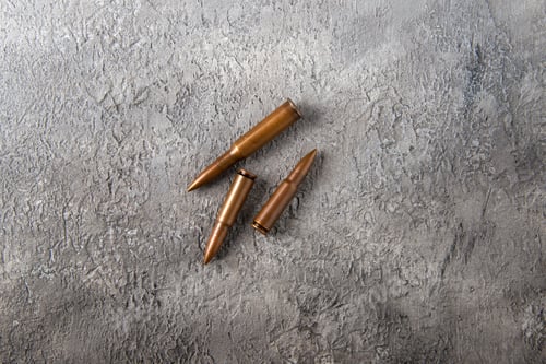 Preview: top view of brown bullets on white surface tank war death soldier gun