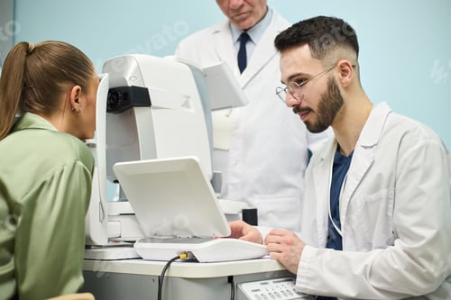 Preview: Optometrist Conducting Eye Exam on Female Patient