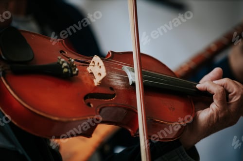 Preview: Closeup shot of male hands playing the violin
