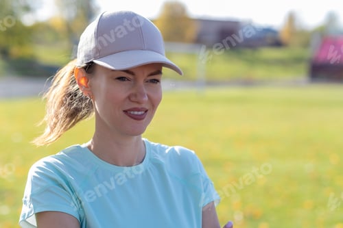 Preview: A young beautiful woman in sportswear plays sports at a local stadium