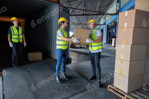 Preview: Worker carry carton box taken from 40 feet steel container on the trailer truck park at warehouse