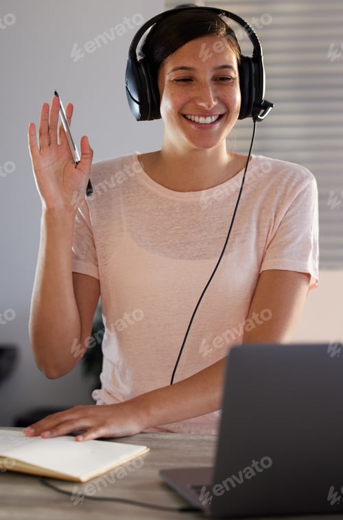 Preview: How many people are attending. Shot of a young woman having a video call while working from home.