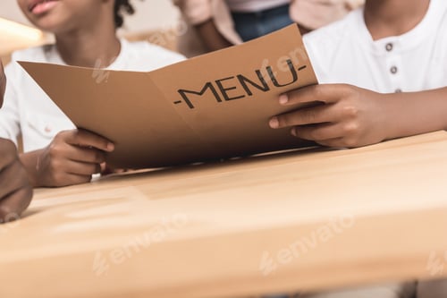 Preview: close-up shot of kids holding menu list