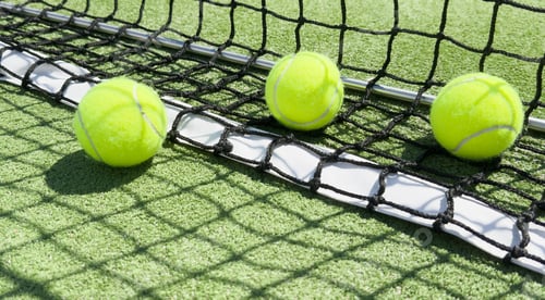 Preview: close up of a padel and tennis court with artificial grass and balls
