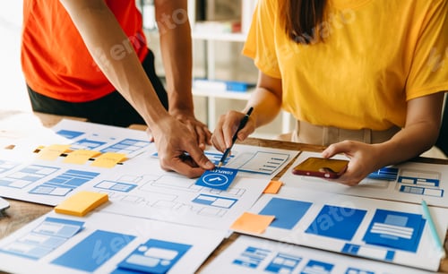Preview: UX developer and ui designer brainstorming about mobile app interface wireframe design with customer