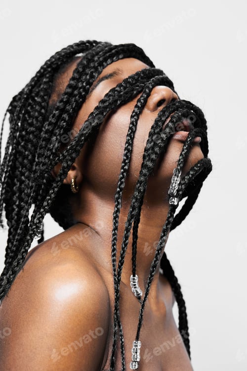 Preview: A stunning portrait of a model with long braided hair, showcasing a unique hairstyle that expresses
