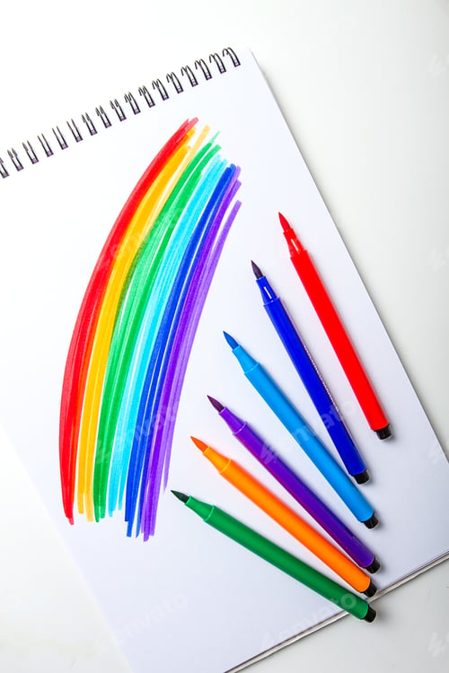 Preview: Watercolor pens brush, rainbow drawing, assortment, on a drawing album, artist's desk, top view,