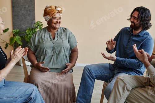 Preview: Adults in a Meeting Room Clapping and Smiling
