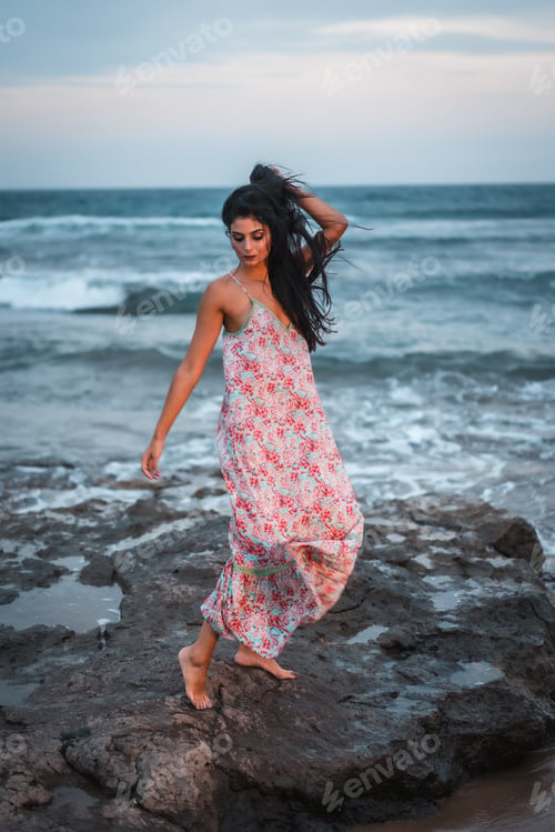 Preview: Posing of a brunette Caucasian in a white fabric dress with flowers