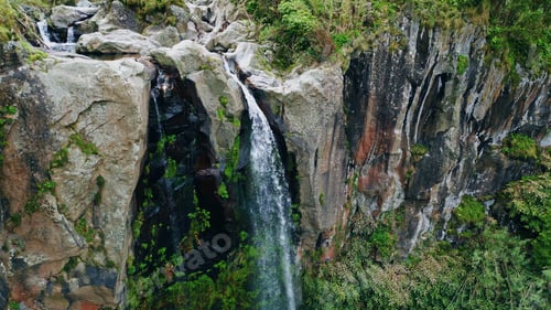 Preview: Water flowing high cliffs terrain aerial view. Force stream crashing mossy rocks
