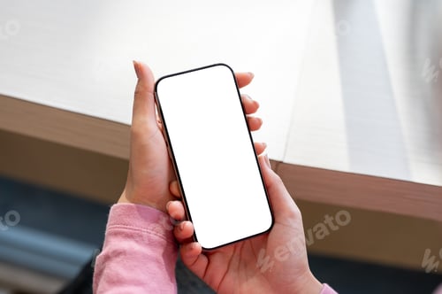 Preview: A woman relaxing in a coffee shop while using her smartphone.