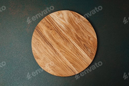 Preview: Wooden round cutting board on a dark surface in a kitchen setting