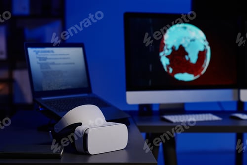 Preview: Selective focus on VR headset lying on workplace of programmer