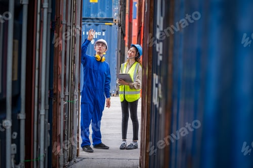 Preview: Professional engineer with worker working at Container yard warehouse.