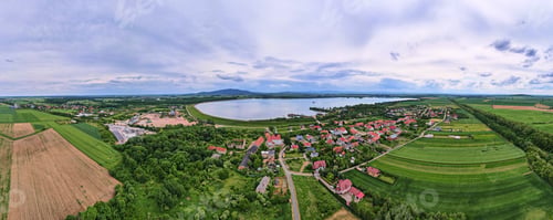 Preview: Aerial landscape with lake and village at cloudy day