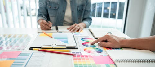 Preview: Two creative graphic designer team working on color selection and drawing on graphic tablet