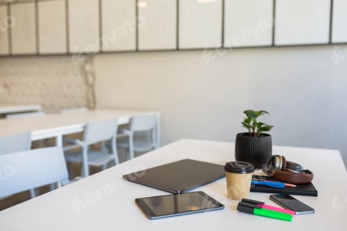 Preview: different office stationery arranged on white table in co-working office, freelancer workplace