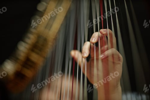 Preview: Fingers of Woman Playing Classic Music on Harp Plucking Strings Gently Indoors