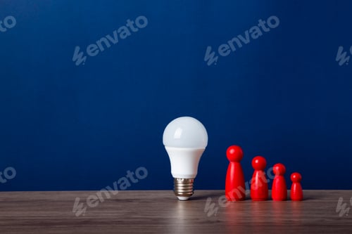 Preview: A light bulb and a wooden doll on the desk
