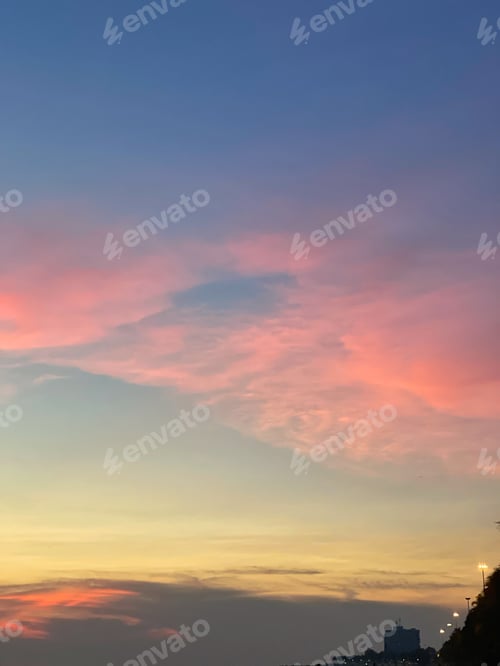 Preview: Beautiful shot of pink clouds in a blue sky with scenery of sunrise