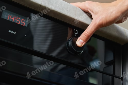 Preview: Female choosing program on electric oven panel