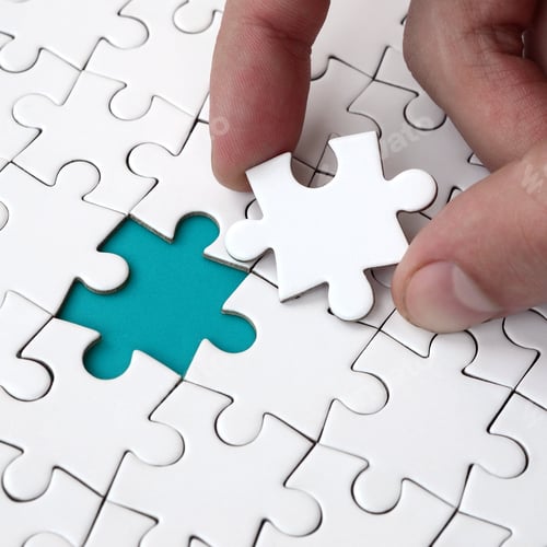 Preview: The human hand fills the last missing elements of the surface from the jigsaw puzzle