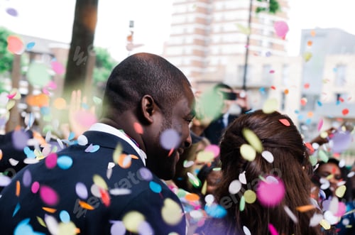 Preview: Multicultural couple wedding day bride and groom confetti.