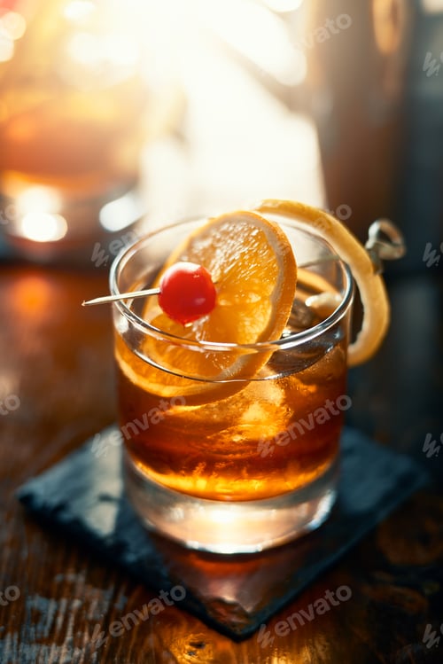 Preview: old fashioned cocktail garnished with cherry, orange and lemon peel