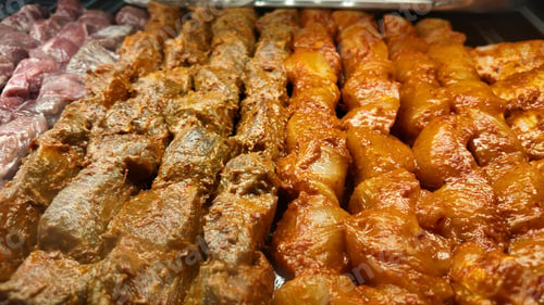 Preview: Grilled meat skewers prepared for an outdoor barbecue event