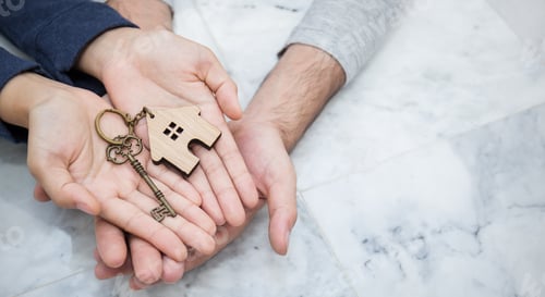 Preview: Closeup real estate or couple hands holding and giving key house on marble background