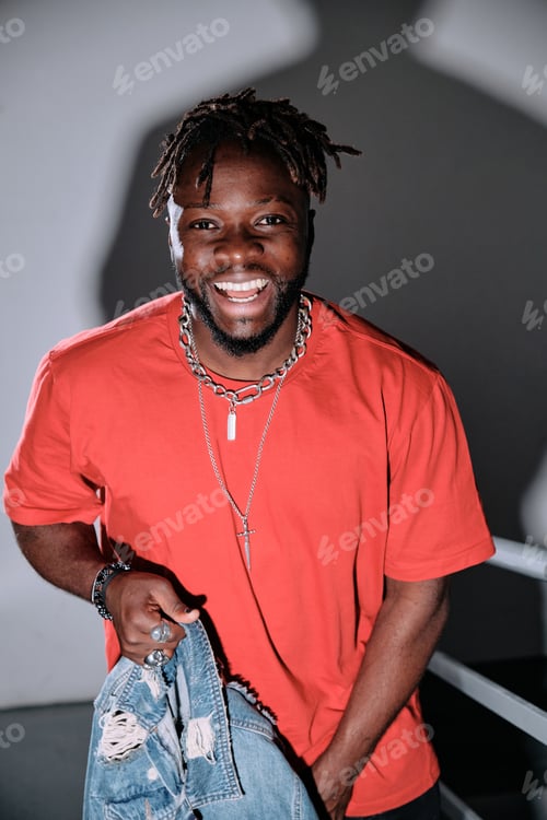Preview: Smiling African American man standing on staircase