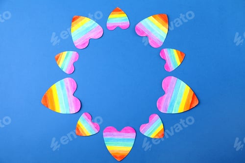 Preview: Top view of rainbow hearts on color background, space for text. Gay symbol