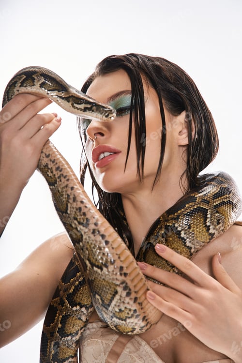 Preview: Captivating young woman interacts with a striking snake in a bold artistic display