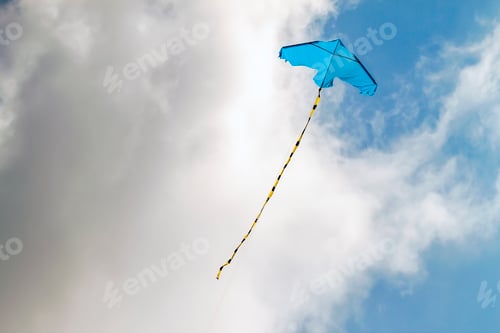 Preview: Kite flying against the blue sky on a sunny day