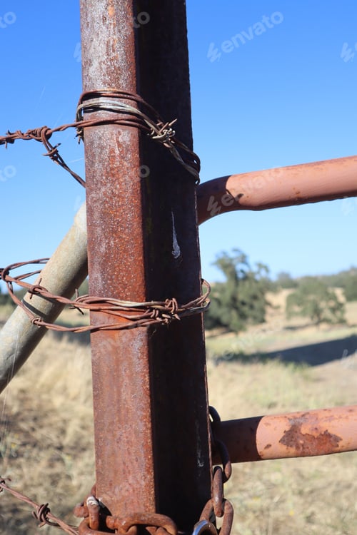 Preview: Vertical closeup of rusted gate fence post at a horse ranch in Amador County, California