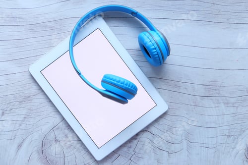 Preview: Audio book concept. Headphones and digital tablet on table