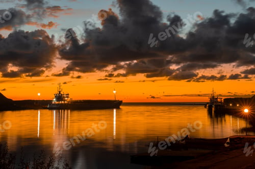 Preview: Container ship in port at container terminal in night time