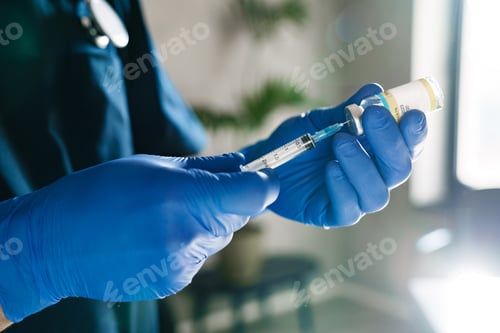 Preview: Mid aged male doctor wearing protective mask