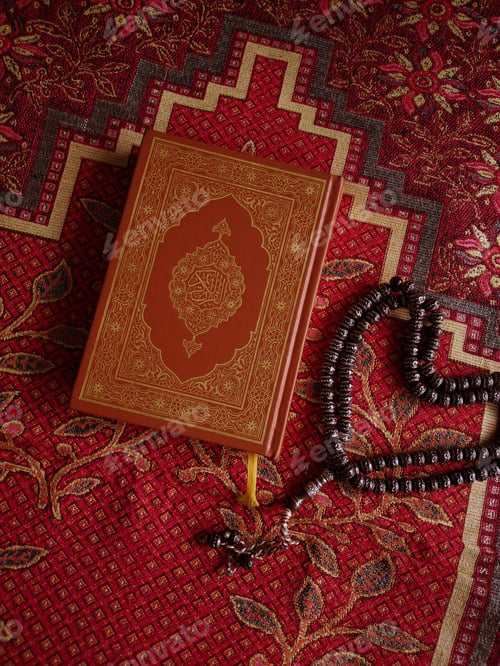 Preview: Muslim prayer beads, Quran and space for text on prayer mat background, top view