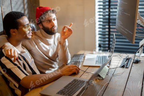 Preview: Gay couple working on computers at home office