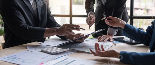 Preview: Business People Meeting using laptop computer,calculator,notebook,stock market chart paper for