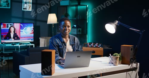 Preview: Joyful remote worker using notebook to send emails to business partners