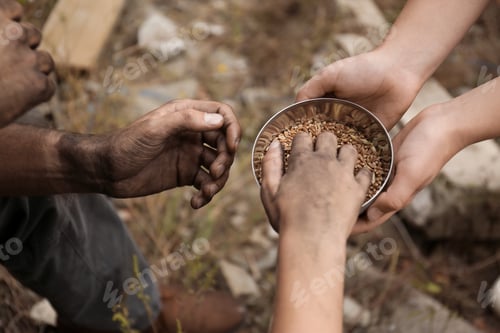 Preview: Woman giving poor homeless people bowl of wheat outdoors, closeup