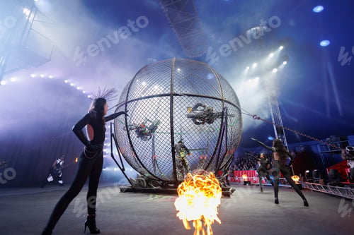 Preview: Dangerous show involving motorcyclists in circus. Stuntmen ride motorcycles in metal round cage.