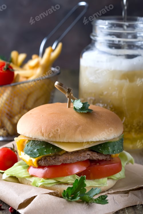 Preview: Tasty grilled prawn and beef burger with lettuce and mayonnaise served on pieces of brown paper on a